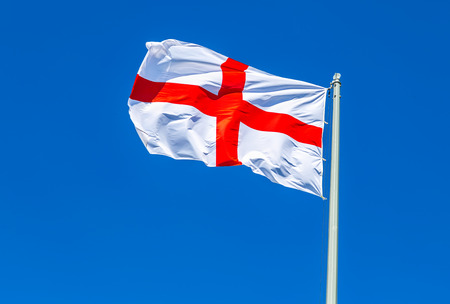 National flag of England waving in the wind against the blue skyの写真素材