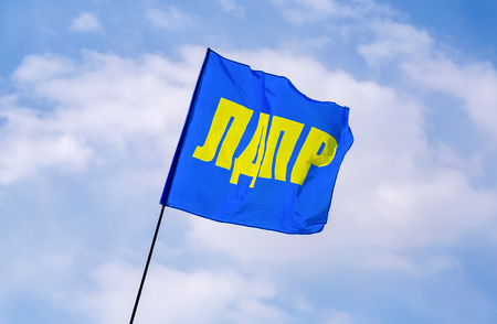 Samara, Russia - May 1, 2019: Flag of Liberal Democratic Party of Russia (LDPR) against the blue skyのeditorial素材