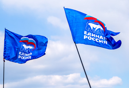 Samara, Russia - May 1, 2019: Flags of the party United Russia against the blue skyのeditorial素材