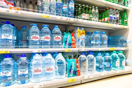 Samara, Russia - June 9, 2019: Different bottled fresh cool water ready for sale in supermarketのeditorial素材
