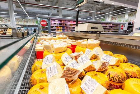 Samara, Russia - June 9, 2019: Tasty freshly cheese ready to sale in the showcase at the chain supermarketのeditorial素材