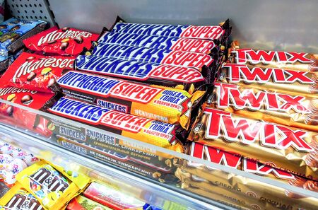 Samara, Russia - May 25, 2019: Twix and snickers chocolate bars on store shelfのeditorial素材