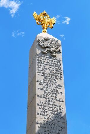 Moscow, Russia - July 9, 2019: Top of the Romanov's (Romanovsky) monument, Double-headed Eagle and Griffin with Sword and Shield, in Alexander Garden against the blue skyのeditorial素材