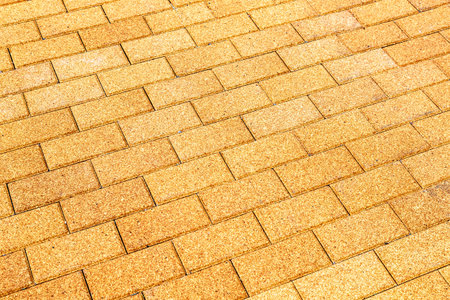Yellow ceramic paving stones as background texture close up