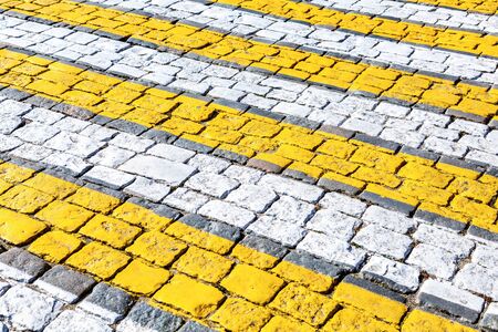 Pedestrian crossing with white and yellow stripes close upの写真素材