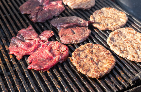 Appetizing pieces of grilled meat cooked on the grill over the hot charcoals