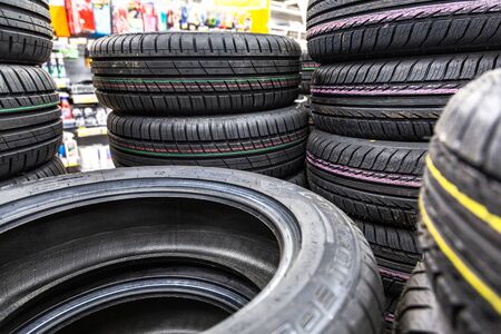 Samara, Russia - May 25, 2019: Summer vehicle tires stacked up for sale at the store. New tyres for saleのeditorial素材