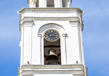 Russian orthodox church. Fragment of bell tower of the Iversky monastery with bell and chime clock...