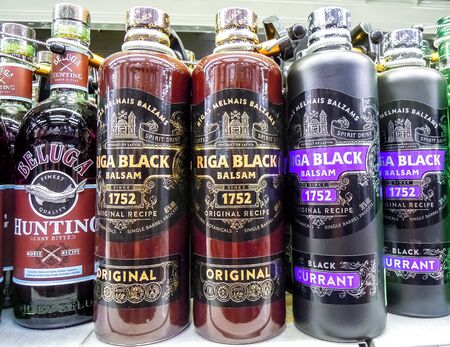 Samara, Russia - February 8, 2020: Riga Black Balsam is a traditional Latvian herbal liqueur ready for sale on the shelf in superstore. Various bottled alcoholic beverages and spirit drinksのeditorial素材