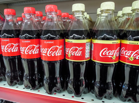 Samara, Russia - March 21, 2020: Coca Cola drinks ready for sale on the shelf in superstore. Various...