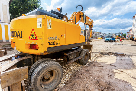 Borovichi, Russia - July 22, 2019: Backhoe working on the construction of new road in summer day