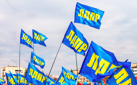 Samara, Russia - May 1, 2018: Flags of Liberal Democratic Party of Russia (LDPR) against the blue...