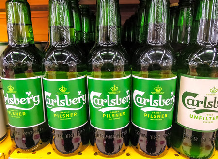 Samara, Russia - March 18, 2020: Carlsberg alcoholic beer ready for sale on the shelf in superstore. Various bottled alcoholic beverages and spirit drinksのeditorial素材