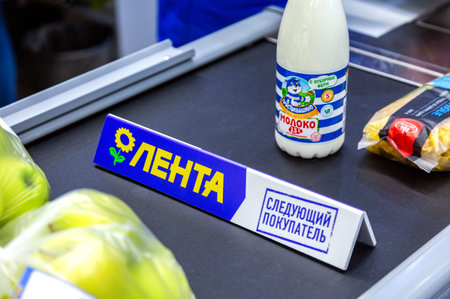 Samara, Russia - November 23, 2019: Goods separator on the conveyor belt in hypermarket Lenta. Text...
