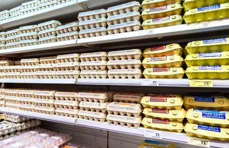 Samara, Russia - November 24, 2019: Different fresh chicken eggs in boxes ready for sale on the shelves at the grocery storeのeditorial素材