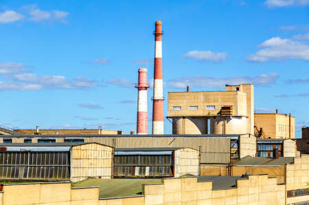 Large industrial plant with big chimneys against the blue skyの写真素材