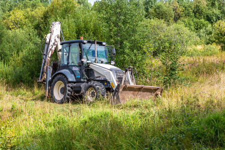 Novgorod, Russia - August 14, 2020: Bulldozer working at the countryside in summer day