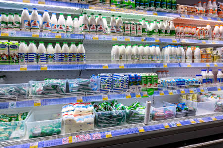Samara, Russia - April 7, 2019: Various fresh dairy products ready for sale in chain hypermarket. Packaged milk as food backgroundのeditorial素材