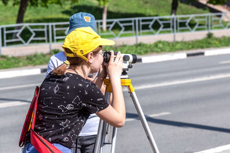 Samara, Russia - June 12, 2019: Surveyor engineer worker making measuring with geodetic optical level. Topographic survey. Geodetic worksのeditorial素材