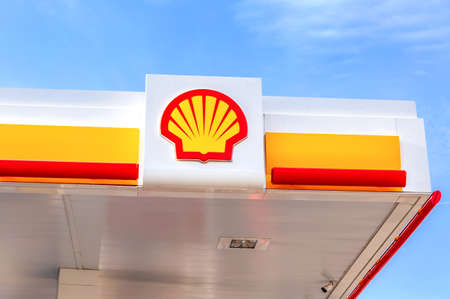Samara, Russia - October 8, 2020: Emblem of the Royal Dutch Shell oil company against the blue skyのeditorial素材