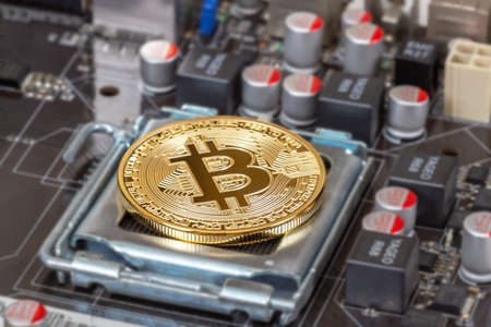 Samara, Russia - December 11, 2017: Cryptocurrency Bitcoin lying over electronic computer component. Business concept of digital moneyのeditorial素材