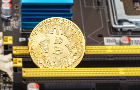Samara, Russia - December 11, 2017: Cryptocurrency Bitcoin lying over electronic computer component....