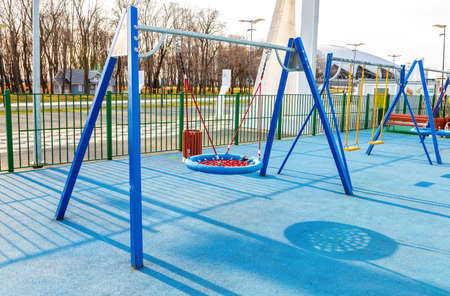 Samara, Russia - October 30, 2020: Children's playground for kids in new district with swing for play and rest. Recreation site with swing in cityのeditorial素材