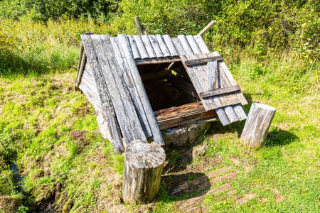 Old wooden water well at the countryside in summer sunny dayの写真素材