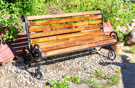 Lonely wooden bench at the city street in summer sunny dayの写真素材