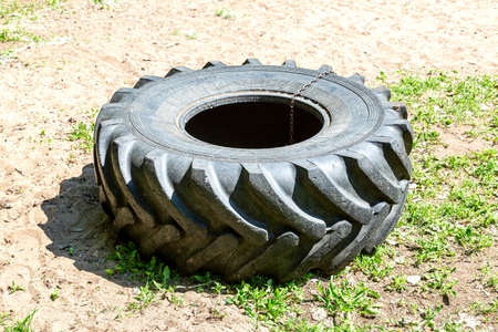 Samara, Russia - May 16, 2021: Large car tire for sports strength trainingのeditorial素材