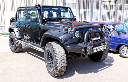 Samara, Russia - May 15, 2021: Tuned Jeep Wrangler vehicle at the city street. Black all terrain...