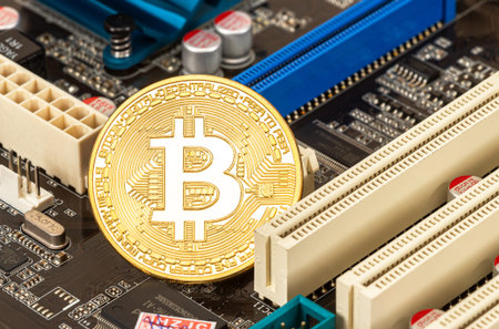 Samara, Russia - December 11, 2017: Bitcoin Cryptocurrency lying over electronic computer component....