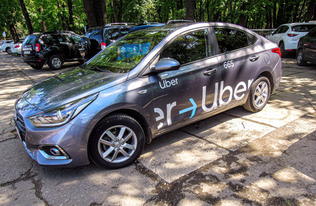 Samara, Russia - June 5, 2021: Uber taxi is parked on a city street in summer