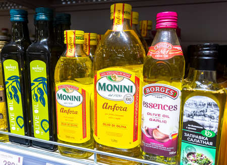 Samara, Russia - June 13, 2021: Assorted olive oils in bottles ready for sale in the superstore. Bottled olive oilsのeditorial素材