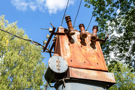 Old voltage power transformer substation at the countryside in summerの写真素材