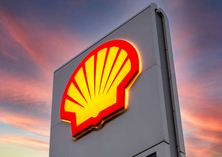 Moscow, Russia - July 5, 2021: Glowing emblem of Shell gas station against the sky. Shell fuel stationのeditorial素材