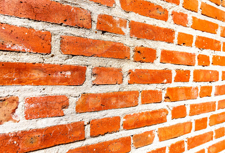 Weathered red brick wall as background. View from the angle