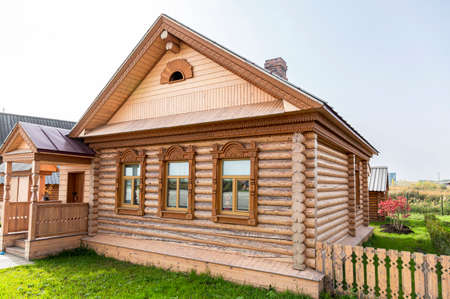 Samara, Russia - September 25, 2021: Ethnocultural complex "People's Friendship Park". Traditional Mordovian wooden house built from wood logs. Mordovian wooden house with decorative carvedのeditorial素材