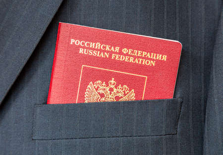 Russian passport in business suit pocket close upの写真素材