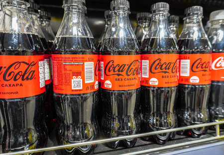 Samara, Russia - March 11, 2022: Coca Cola drinks ready for sale on the shelf in a superstore....
