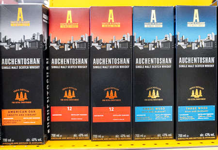Samara, Russia - March 22, 2022: Auchentoshan Whiskey on the shelf at the superstore. Bottled alcoholic drinks and spirits. Strong alcoholic beveragesのeditorial素材