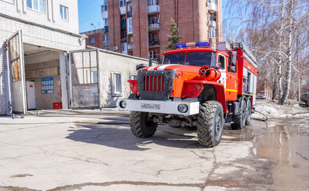 Samara, Russia - April 07, 2022: Red fire truck parked near the fire station in sunny day