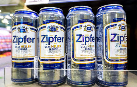 Samara, Russia - April 16, 2022: Zipfer alcoholic canned beer on the shelf in superstore. Austrian beer. Various alcoholic beverages and spirit drinks. selective focusのeditorial素材