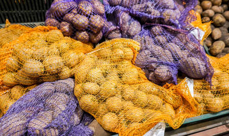 Fresh potatoes packed in bags sold in a superstoreの写真素材