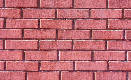 Old weathered red brick wall as background. Brick masonry with seams. Red brick wall texture