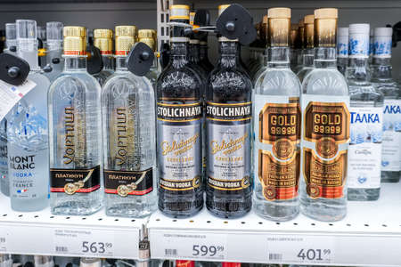 Samara, Russia - April 19, 2022: Stolichnaya russian vodka on the shelf in a superstore. Bottled alcoholic beverages and spirit drinks. Strong alcoholic beverages. selective focusのeditorial素材