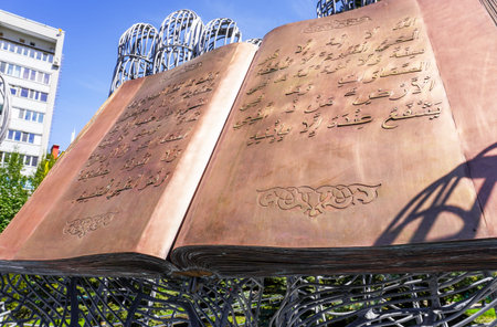 Samara, Russia - May 8, 2022: Sculptural composition Quran in open palms on the territory of the...