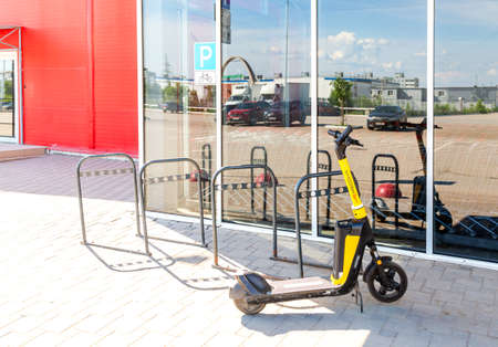 Samara, Russia - June 18, 2022: Metal parking lot for bicycles with road sign. Bicycle parking next the superstoreのeditorial素材