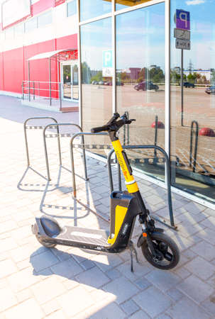 Samara, Russia - June 18, 2022: Metal parking lot for bicycles with road sign. Bicycle parking next the superstoreのeditorial素材