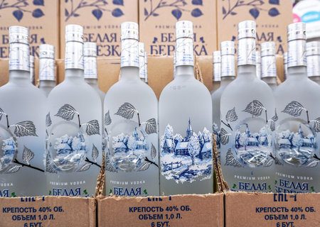 Samara, Russia - July 2, 2022: Belaya Berezka Russian Vodka on the shelf in a superstore. Various bottled alcoholic beverages and spirit drinks. Strong alcoholic beverages. selective focusのeditorial素材